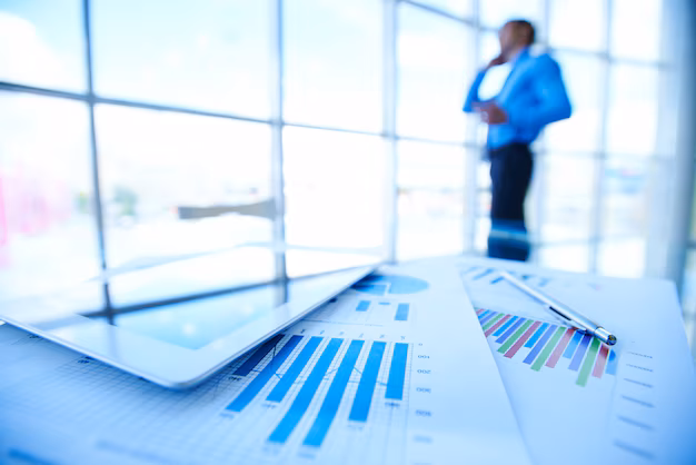 statistic-documents-with-businessman-blurred-background_1098-293